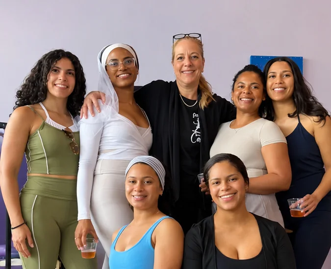 A group of seven women celebrating together at Ascendance after a private group class