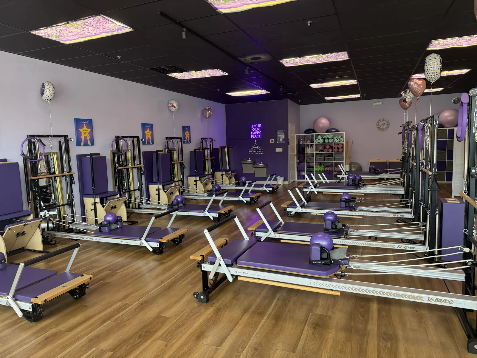 Reformer Pilates studio at Ascendance in Fernandina Beach, with rows of Reformers, lavender walls and star artwork